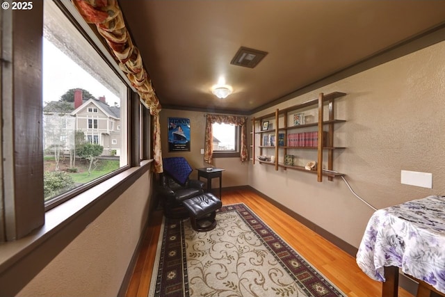 369 37th St, Astoria, OR 97103 - bedroom featuring hardwood / wood-style flooring, wainscoting, wallpapered walls, and a chandelier