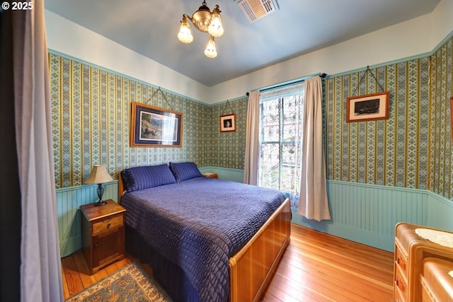 369 37th St, Astoria, OR 97103 - bedroom featuring wood finished floors and wallpapered walls