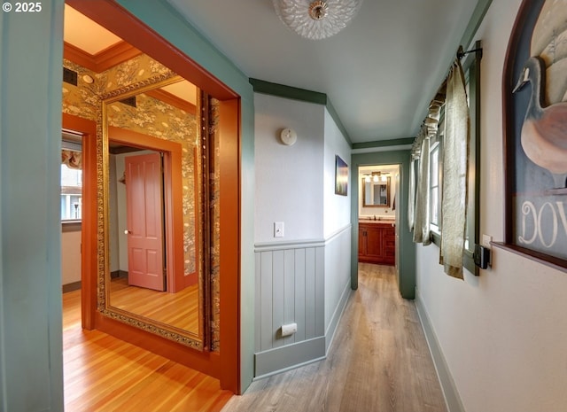 369 37th St, Astoria, OR 97103 - bedroom with a chandelier, light wood finished floors, crown molding, baseboards, and ceiling fan