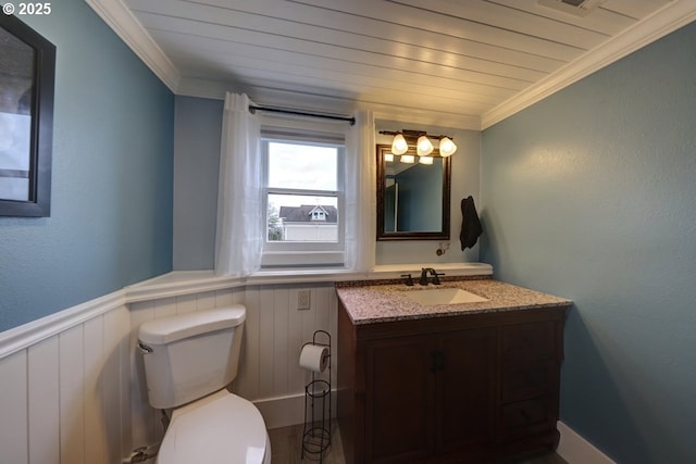 369 37th St, Astoria, OR 97103 - corridor with wood finished floors, ornamental molding, a wainscoted wall, and baseboards