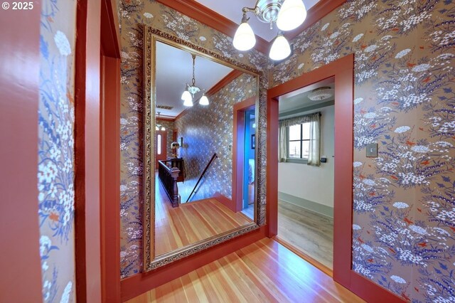 369 37th St, Astoria, OR 97103 - bathroom with a tile shower, wainscoting, crown molding, and a decorative wall