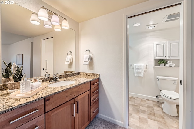 bathroom with vanity and toilet