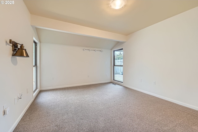 empty room with lofted ceiling and carpet floors