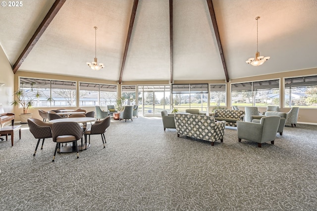 sunroom / solarium featuring vaulted ceiling with beams and an inviting chandelier