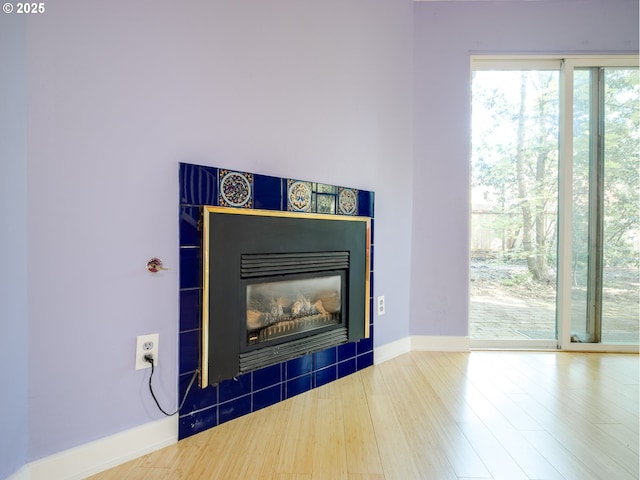 4345 SW 94th Ave, Portland, OR 97225 - room details with baseboards, wood finished floors, and a glass covered fireplace