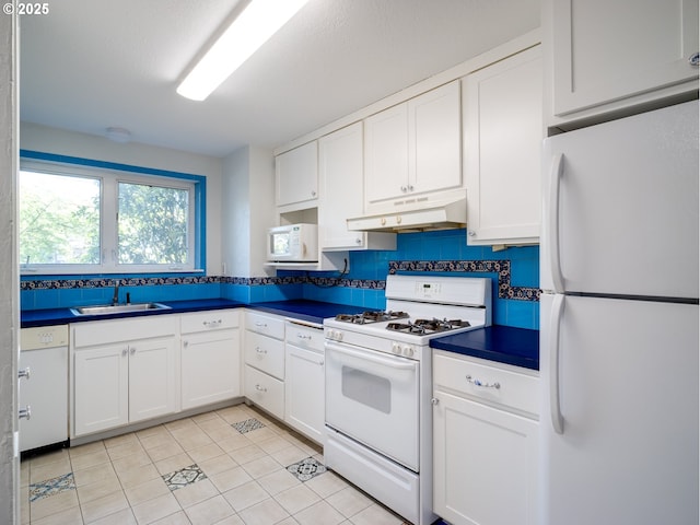 4345 SW 94th Ave, Portland, OR 97225 - kitchen featuring white appliances, under cabinet range hood, white cabinets, dark countertops, and a sink