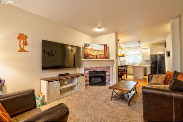 living room featuring a fireplace and sink