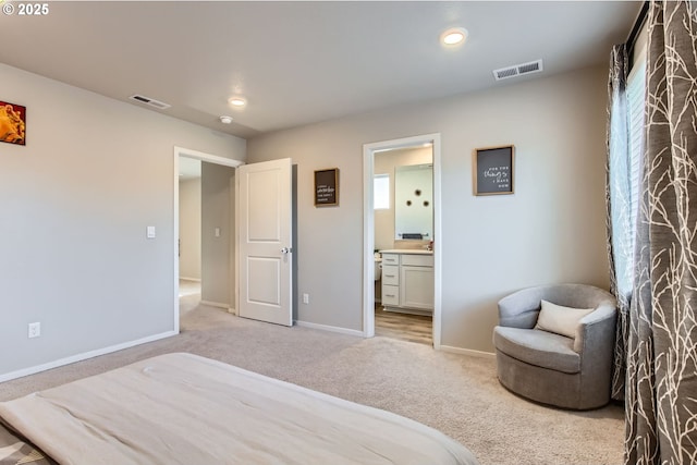 7897 SW Mara Ct, Portland, OR 97224 - bedroom featuring light colored carpet, baseboards, connected bathroom, and recessed lighting