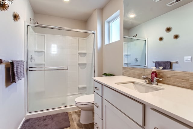 7897 SW Mara Ct, Portland, OR 97224 - bathroom featuring toilet, a shower stall, vanity, wood finished floors, and recessed lighting
