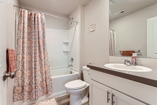 7897 SW Mara Ct, Portland, OR 97224 - bathroom featuring toilet, vanity, shower / bath combo with shower curtain, and wood finished floors