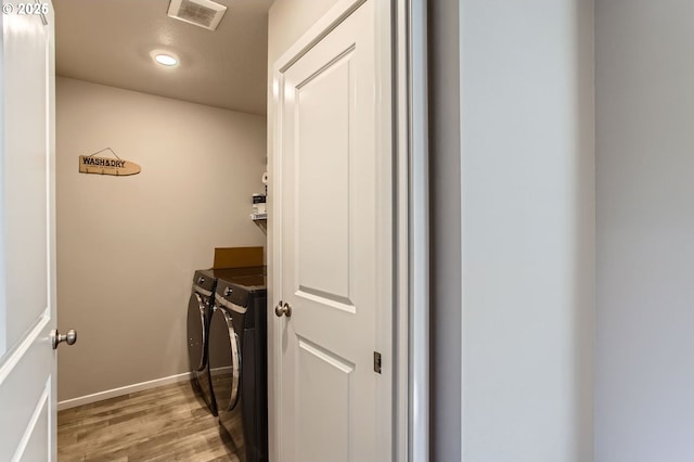 7897 SW Mara Ct, Portland, OR 97224 - washroom featuring washer and clothes dryer, light wood-type flooring, baseboards, and recessed lighting