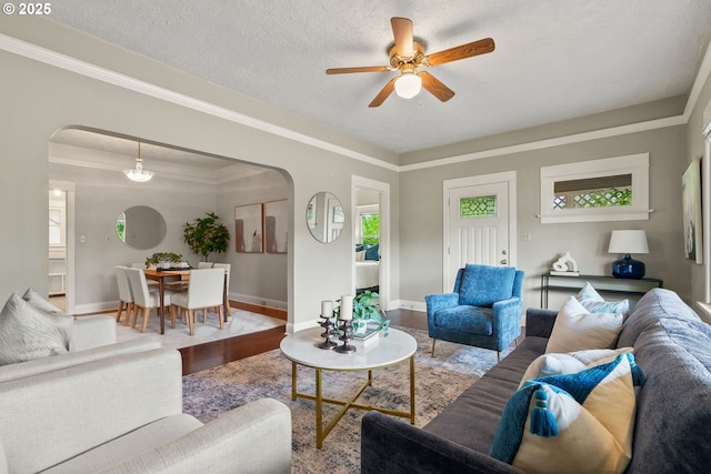 380 W Arlington St, Gladstone, OR 97027 - living area with arched walkways, ceiling fan, wood finished floors, a textured ceiling, and ornamental molding