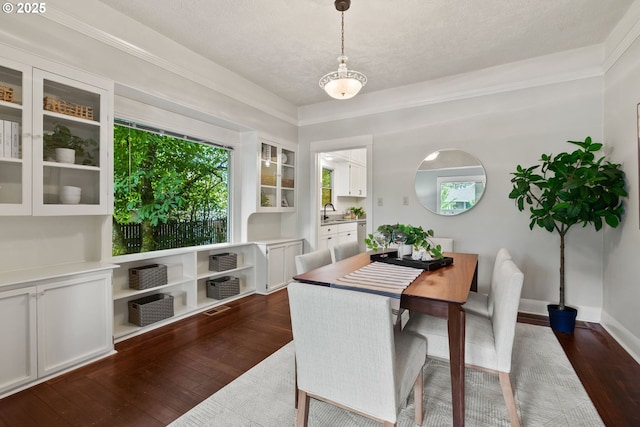 380 W Arlington St, Gladstone, OR 97027 - dining area featuring dark wood-style floors, a textured ceiling, and ornamental molding