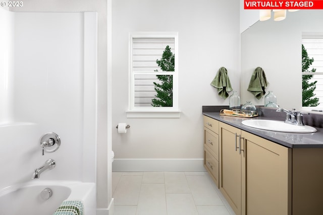 bathroom with tile patterned flooring, shower / tub combination, vanity, and baseboards