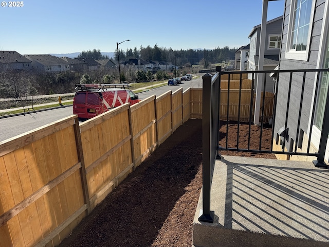 view of yard featuring a residential view and fence