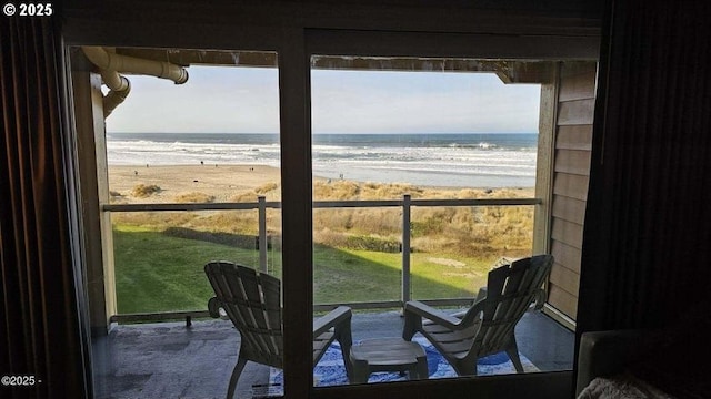 balcony featuring view of water and beach