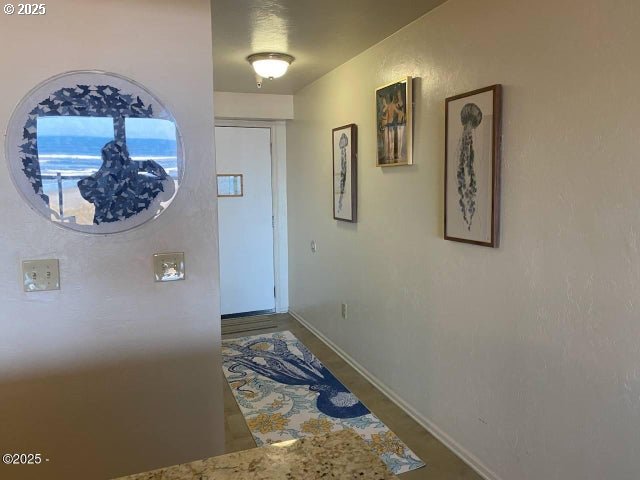 hallway featuring baseboards
