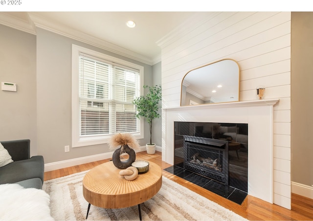 621 NE Randall Ave, Portland, OR 97232 - living room with crown molding, baseboards, wood finished floors, a tile fireplace, and recessed lighting