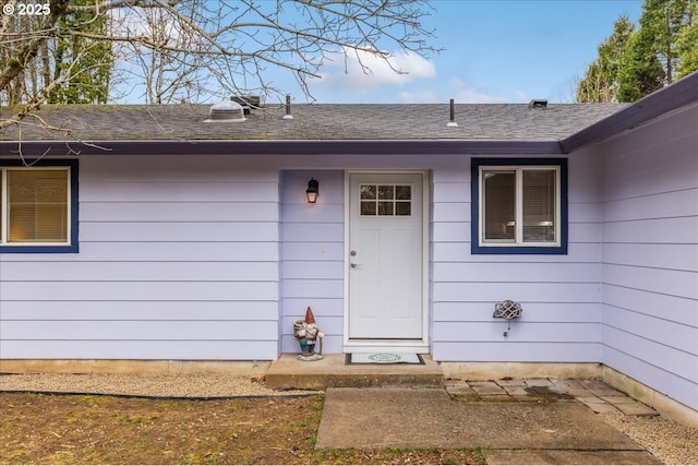 entrance to property with a shingled roof