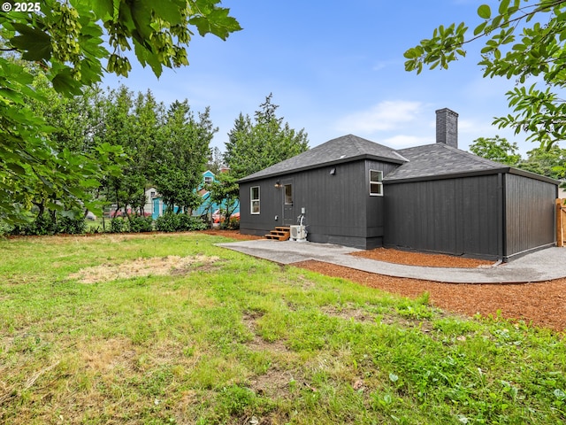 3401 SE 129th Ave, Portland, OR 97236 - rear view of property with roof with shingles, a chimney, a yard, a patio area, and entry steps