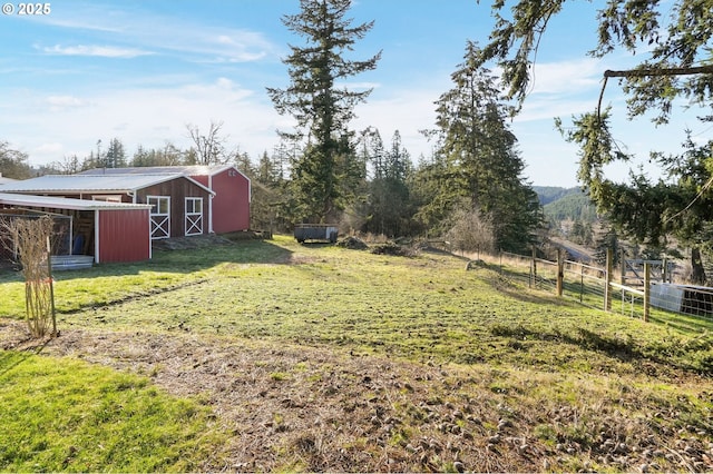 view of yard with an outbuilding and a rural view