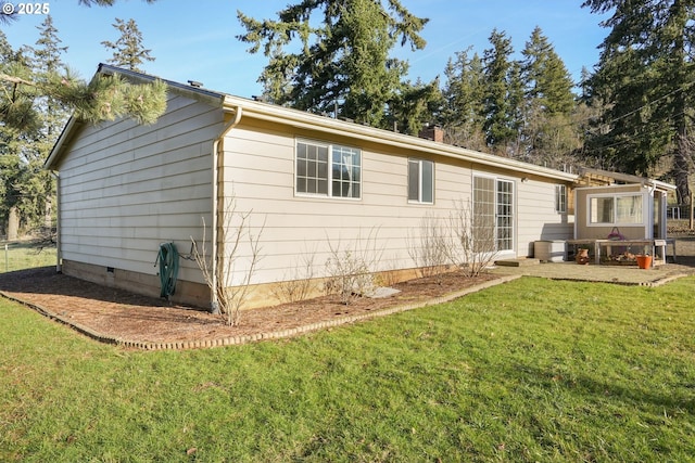 rear view of property with a lawn