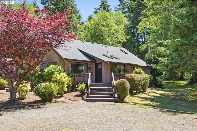 33712 Rainbows End Ln, Warrenton, OR 97146 - rustic home with a shingled roof, stairway, and a wooden deck