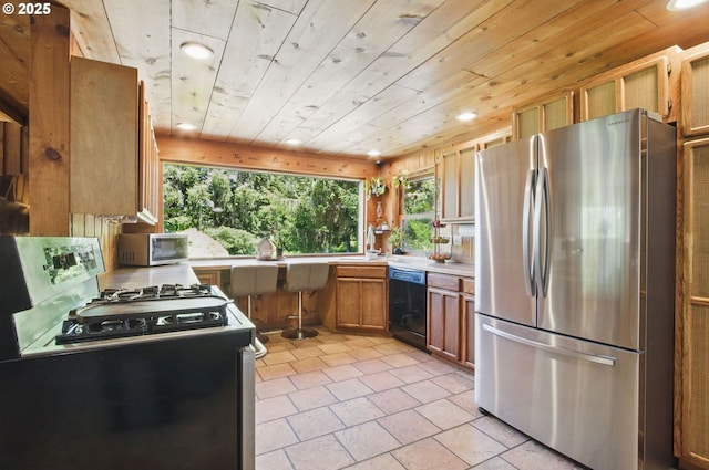 33712 Rainbows End Ln, Warrenton, OR 97146 - kitchen featuring stainless steel appliances, recessed lighting, light countertops, brown cabinets, and a sink