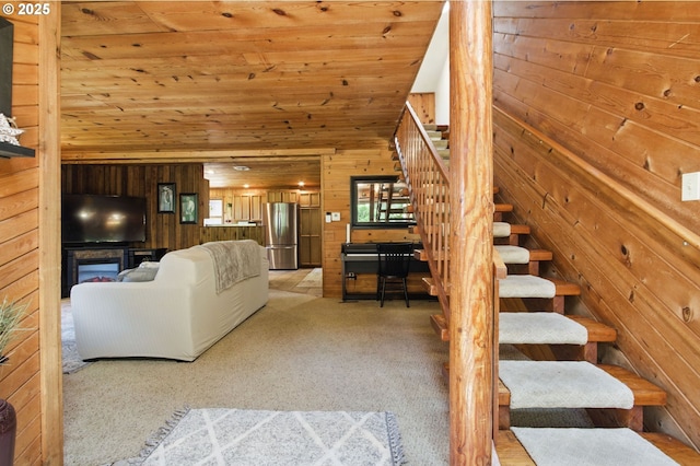 33712 Rainbows End Ln, Warrenton, OR 97146 - living room with wooden walls, light carpet, stairway, and wooden ceiling