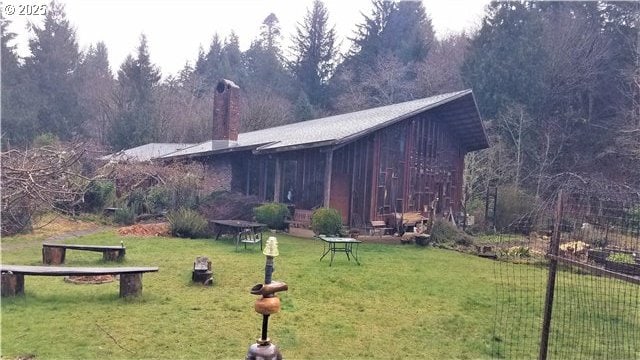 exterior space with a yard and a chimney