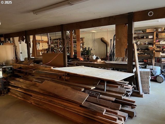 interior space featuring plenty of natural light, a towering ceiling, and hardwood / wood-style flooring