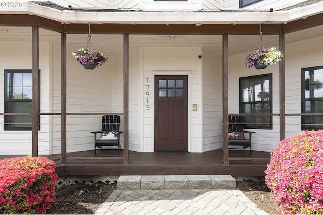 view of exterior entry with a porch