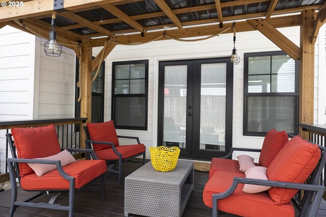 wooden deck with french doors and an outdoor hangout area