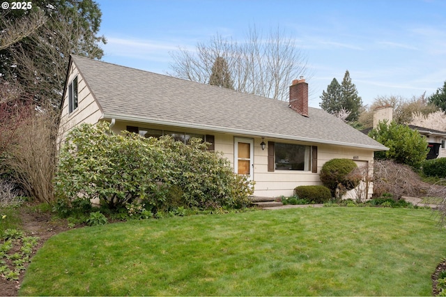 view of front of property with a front yard, a chimney, a garage, and a shingled roof