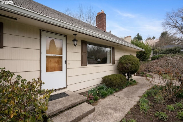 property entrance with a chimney