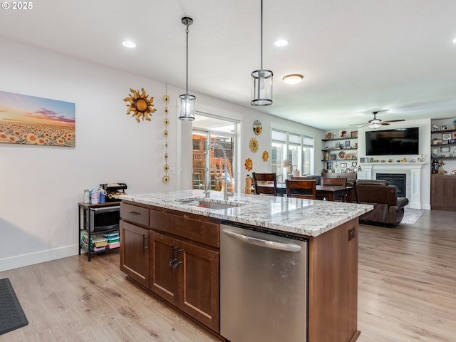 13317 NE 60th Ave, Vancouver, WA 98686 - kitchen featuring stainless steel dishwasher, a fireplace, light wood-type flooring, a ceiling fan, and pendant lighting