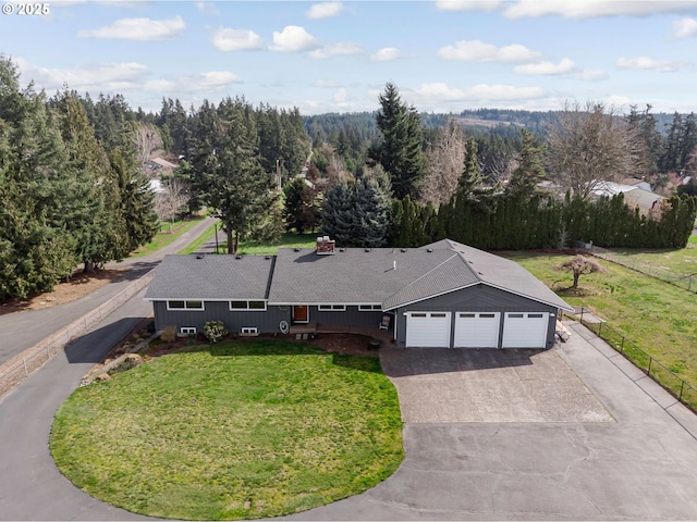 birds eye view of property featuring a wooded view