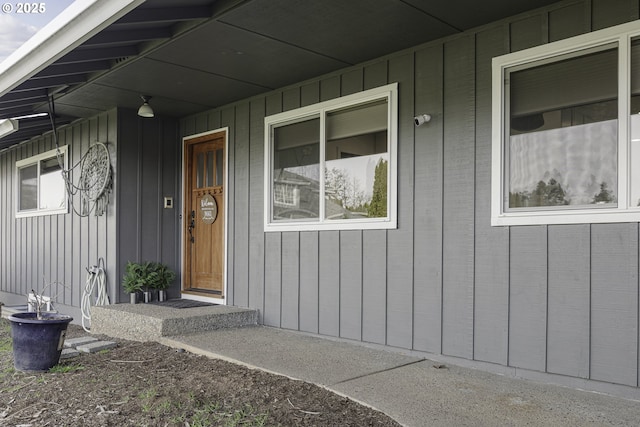 view of exterior entry featuring covered porch