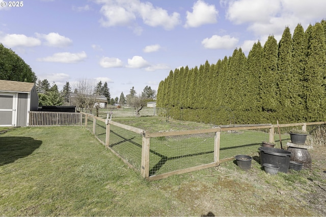 view of yard with an outbuilding, a storage unit, and fence