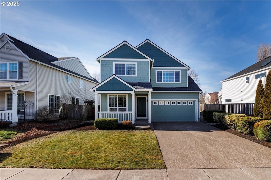 view of front of house with a garage and a front lawn