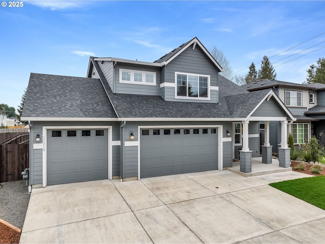 view of front facade featuring concrete driveway, roof with shingles, and fence