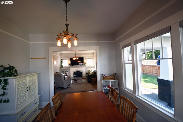 609 E 10th St, The Dalles, OR 97058 - dining area with a chandelier, plenty of natural light, and a fireplace