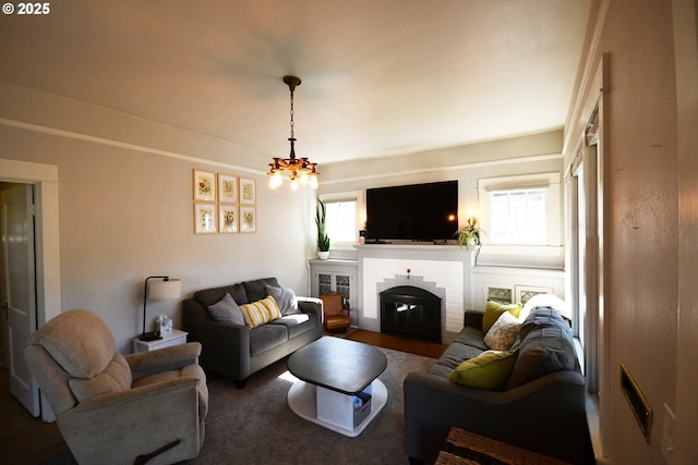 609 E 10th St, The Dalles, OR 97058 - living area with healthy amount of natural light, a chandelier, and a fireplace