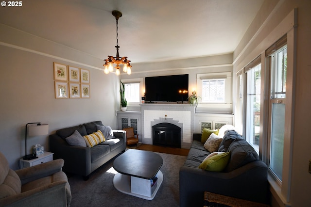 609 E 10th St, The Dalles, OR 97058 - living area with a fireplace and a chandelier