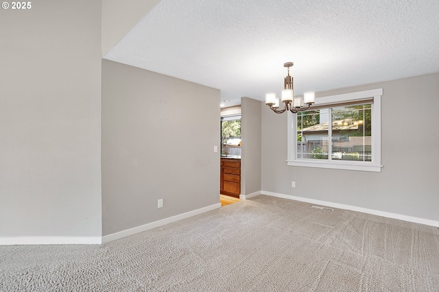 20752 SW 104th Ave, Tualatin, OR 97062 - unfurnished room with a chandelier, light carpet, and a textured ceiling