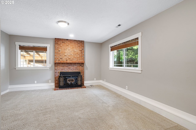 20752 SW 104th Ave, Tualatin, OR 97062 - unfurnished living room featuring healthy amount of natural light, carpet flooring, and a textured ceiling