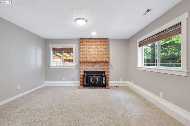 20752 SW 104th Ave, Tualatin, OR 97062 - unfurnished living room with carpet, plenty of natural light, a textured ceiling, and a wood stove