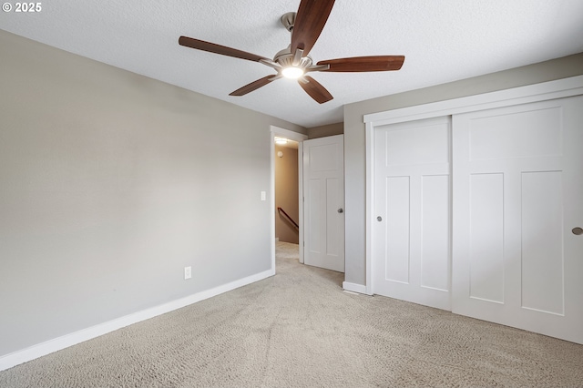 20752 SW 104th Ave, Tualatin, OR 97062 - unfurnished bedroom featuring light carpet, a closet, a textured ceiling, and a ceiling fan