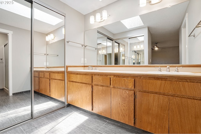 20752 SW 104th Ave, Tualatin, OR 97062 - full bathroom with a skylight, double vanity, tile patterned floors, and a ceiling fan