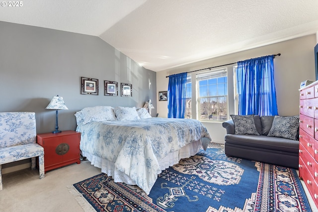 carpeted bedroom featuring lofted ceiling and a textured ceiling